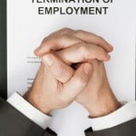 man with clasped hands over termination of employment document