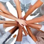 Business people standing with hands together