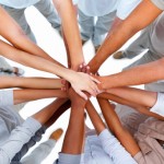 Business people standing with hands together