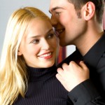 Two young attractive happy smiling business people or couple tel