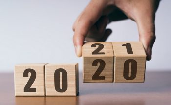 New year 2020 change to 2021 concept, hand change wooden cubes