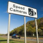 Speed cameras sign with car