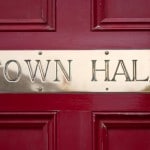 Brass Town Hall sign on a door.