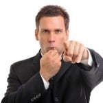 Businessman blowing whistle